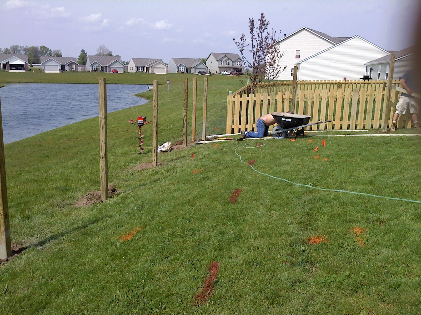 Fence posts going in along a property line