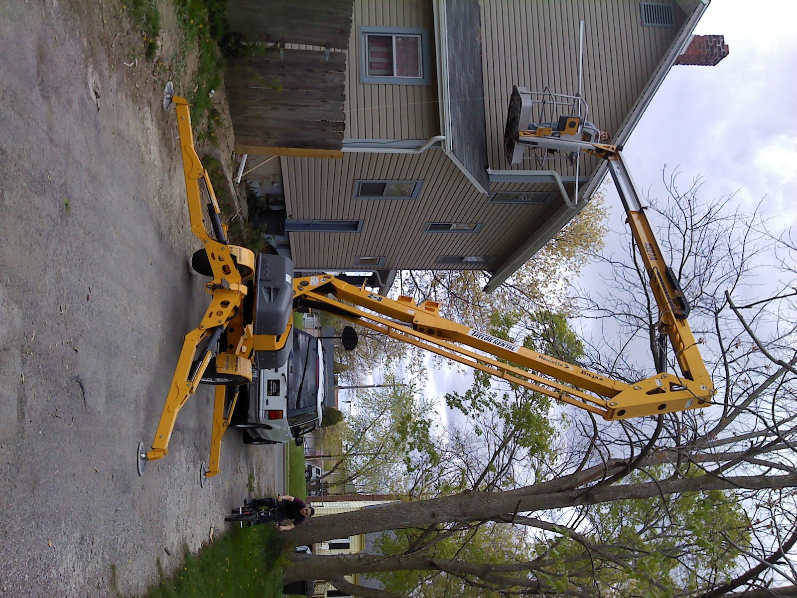 Storm damage cleanup with crane on site
